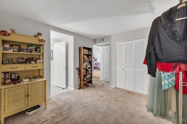 611 W 15th St Unit F1, Tulsa, OK 74127 - carpeted bedroom with a closet and baseboards