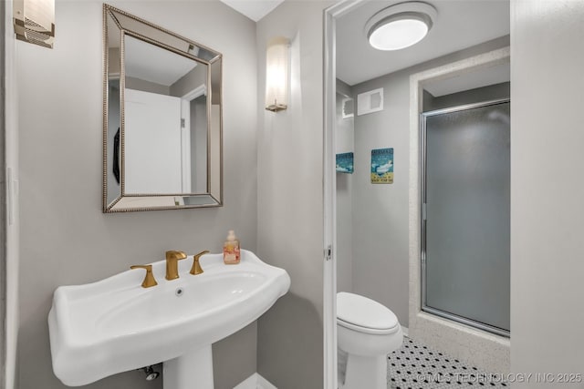 611 W 15th St Unit F1, Tulsa, OK 74127 - bathroom featuring a shower stall, toilet, a sink, and baseboards