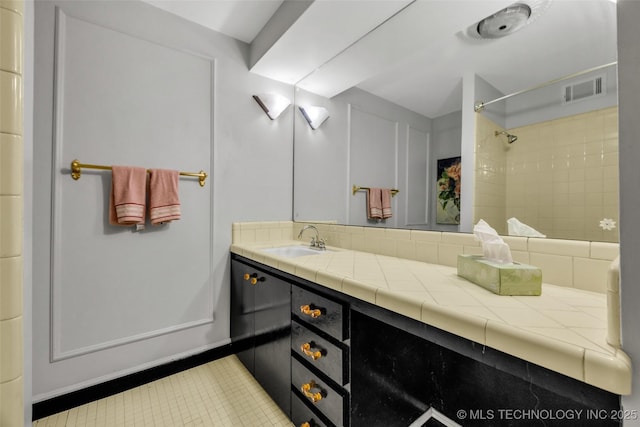 611 W 15th St Unit F1, Tulsa, OK 74127 - bathroom with vanity, a shower, and tile patterned floors