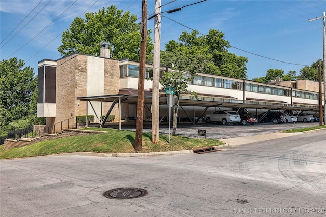 611 W 15th St Unit F1, Tulsa, OK 74127 - view of building exterior with covered parking