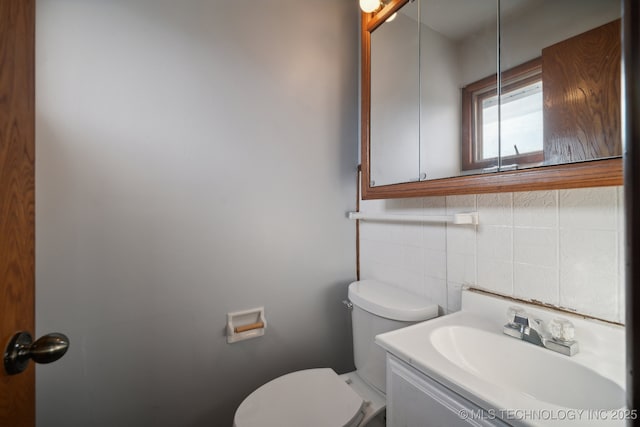 5856 E 22nd St, Tulsa, OK 74114 - bathroom with toilet, decorative backsplash, vanity, and tile walls