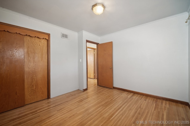 5856 E 22nd St, Tulsa, OK 74114 - unfurnished bedroom with wood finished floors, crown molding, and a closet