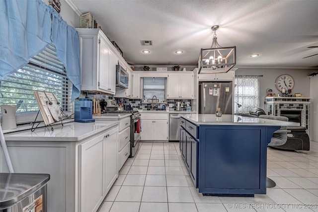 302 E Allen, Davis, OK 73030 - kitchen with appliances with stainless steel finishes, ornamental molding, a sink, a chandelier, and backsplash