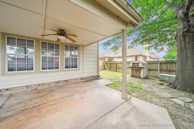 7408 S 94th Ave E, Tulsa, OK 74133 - fenced backyard with a ceiling fan, a patio, and a storage shed