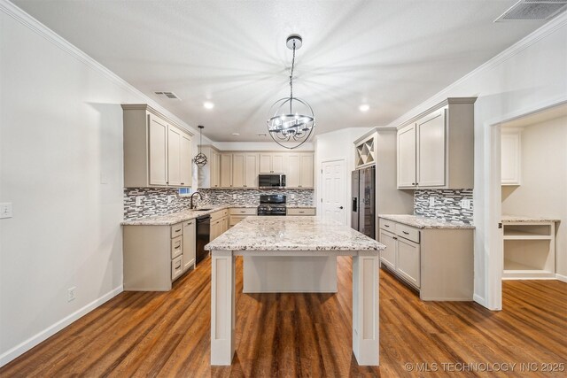 7408 S 94th Ave E, Tulsa, OK 74133 - kitchen with stainless steel appliances, a sink, a chandelier, tasteful backsplash, and a kitchen island