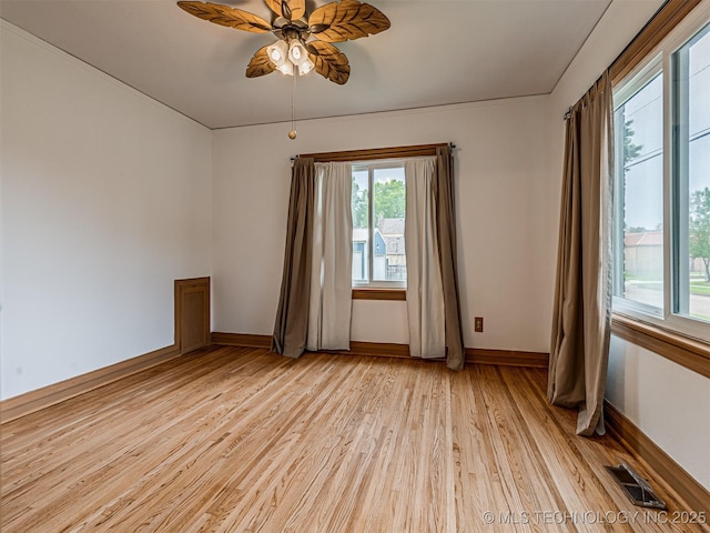 3504 E Haskell St, Tulsa, OK 74115 - unfurnished room with light wood finished floors, baseboards, and a ceiling fan