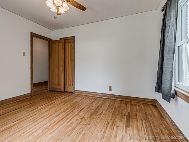 3504 E Haskell St, Tulsa, OK 74115 - unfurnished room with light wood-style flooring, a ceiling fan, and baseboards