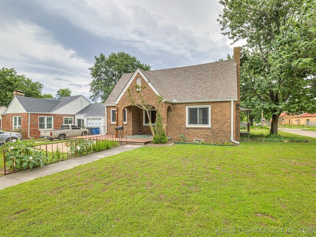 3504 E Haskell St, Tulsa, OK 74115 - view of front of property with brick siding, a front yard, roof with shingles, a porch, and a chimney