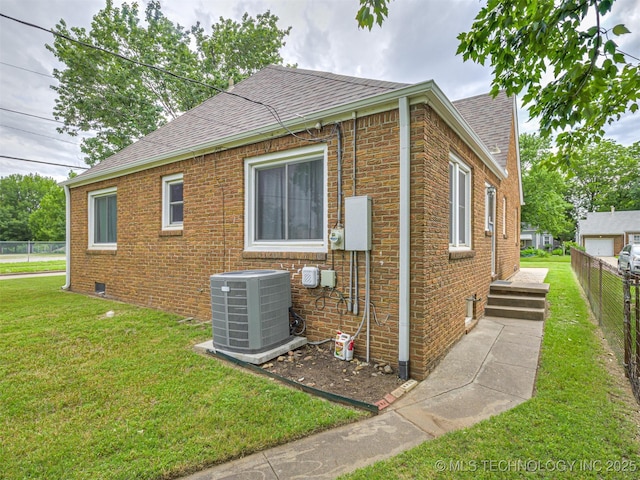 3504 E Haskell St, Tulsa, OK 74115 - view of side of property featuring central AC unit, a shingled roof, and brick siding