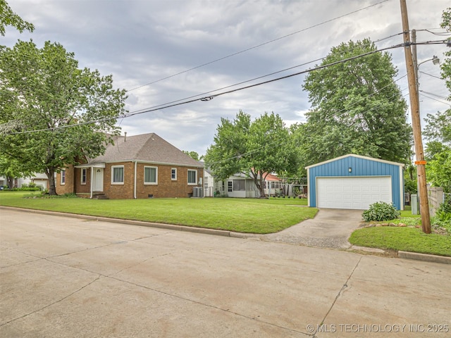 3504 E Haskell St, Tulsa, OK 74115 - view of front of house with an outdoor structure, brick siding, a front yard, a garage, and central AC