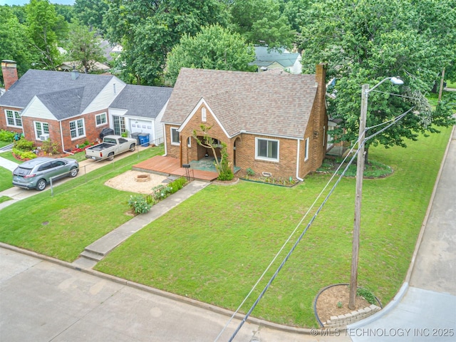 3504 E Haskell St, Tulsa, OK 74115 - view of front of home featuring brick siding, a front lawn, a porch, and roof with shingles