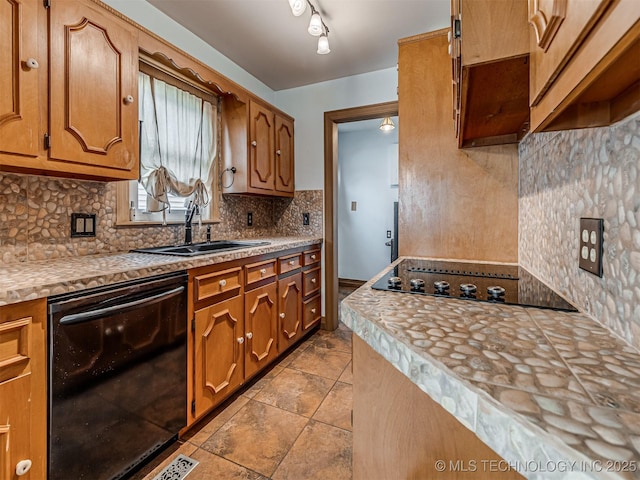 3504 E Haskell St, Tulsa, OK 74115 - kitchen featuring black appliances, tasteful backsplash, light countertops, brown cabinetry, and light tile patterned flooring