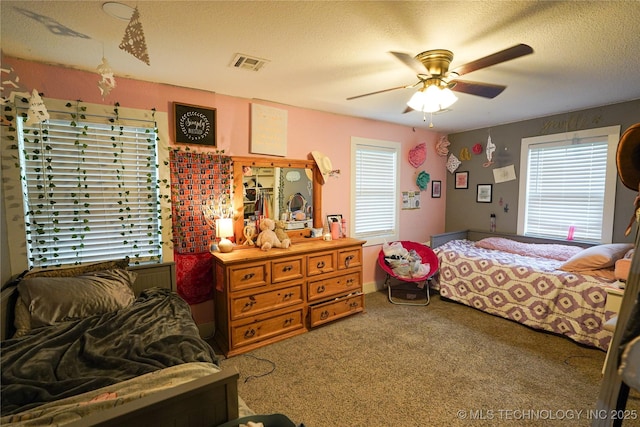 9406 S 161st Ave W, Sapulpa, OK 74066 - carpeted bedroom with multiple windows, a textured ceiling, and a ceiling fan