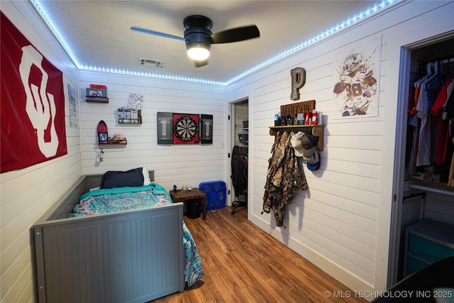 9406 S 161st Ave W, Sapulpa, OK 74066 - bedroom featuring wood finished floors, wood walls, and ceiling fan