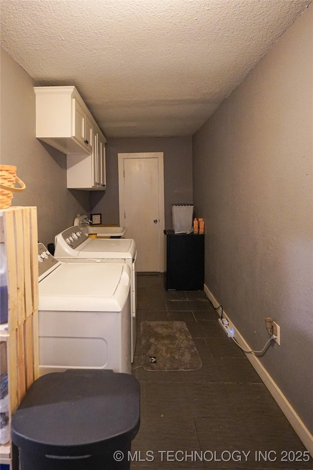 9406 S 161st Ave W, Sapulpa, OK 74066 - laundry area featuring cabinet space, washer and clothes dryer, a textured ceiling, and baseboards