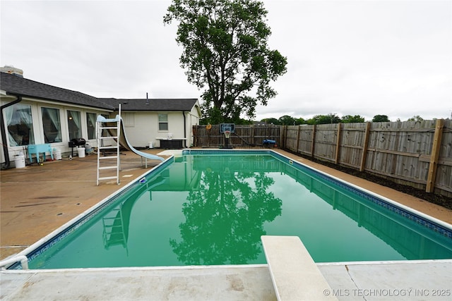 9406 S 161st Ave W, Sapulpa, OK 74066 - view of pool featuring a water slide, a diving board, a fenced backyard, and a patio area