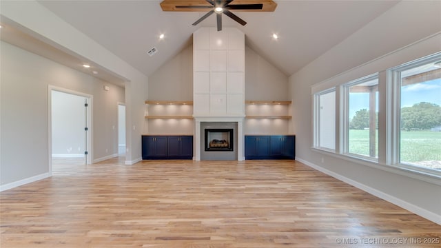 13801 N 54th E Ave, Collinsville, OK 74021 - unfurnished living room with a ceiling fan, high vaulted ceiling, light wood-type flooring, baseboards, and a large fireplace