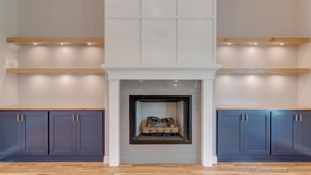 13801 N 54th E Ave, Collinsville, OK 74021 - detailed view of wood finished floors and a tiled fireplace