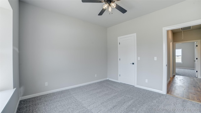 13801 N 54th E Ave, Collinsville, OK 74021 - unfurnished bedroom with carpet floors, baseboards, attic access, and a ceiling fan