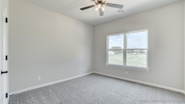 13801 N 54th E Ave, Collinsville, OK 74021 - carpeted spare room with baseboards and a ceiling fan
