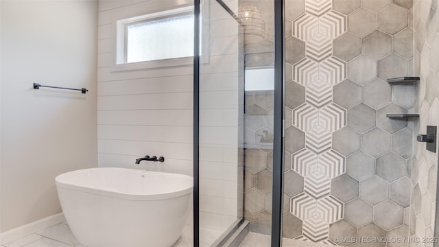 13801 N 54th E Ave, Collinsville, OK 74021 - bathroom with a shower stall, a freestanding tub, baseboards, and marble look tiles