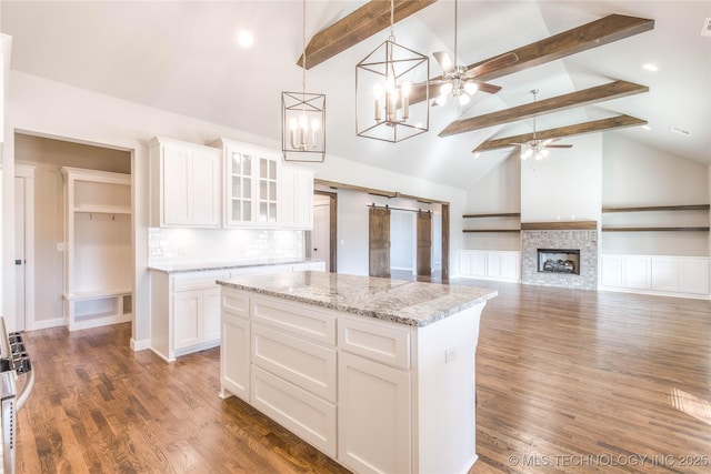 13801 N 54th E Ave, Collinsville, OK 74021 - kitchen featuring high vaulted ceiling, beam ceiling, a ceiling fan, a kitchen island, and white cabinets