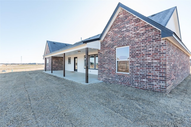 13801 N 54th E Ave, Collinsville, OK 74021 - rear view of property featuring brick siding and a patio