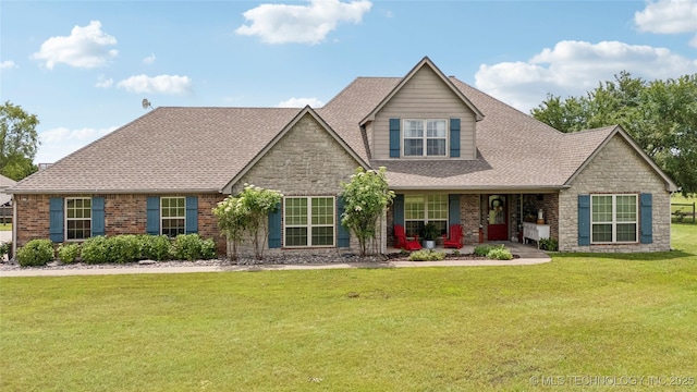 13100 S 4080th Rd, Oologah, OK 74053 - view of front of house with stone siding, a front lawn, a porch, roof with shingles, and brick siding