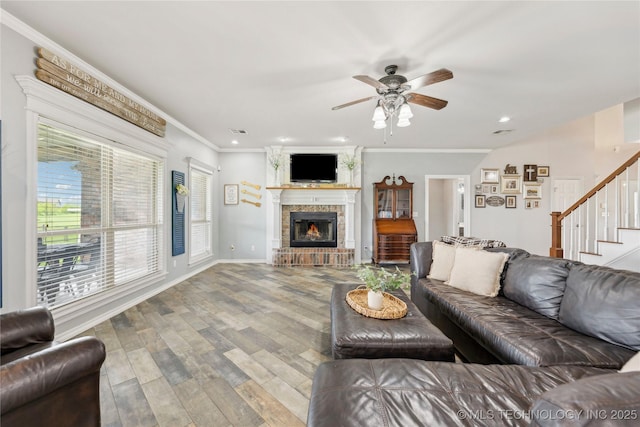 13100 S 4080th Rd, Oologah, OK 74053 - living room featuring wood finished floors, stairway, ornamental molding, a ceiling fan, and a brick fireplace