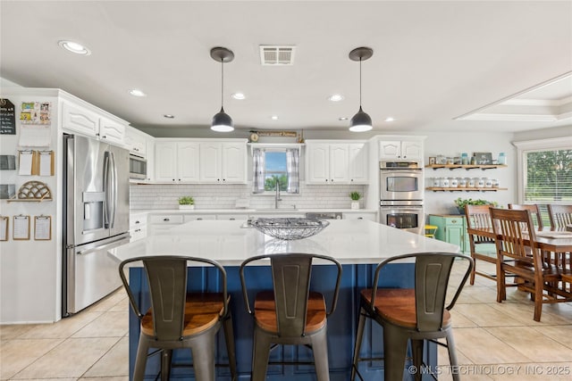 13100 S 4080th Rd, Oologah, OK 74053 - kitchen featuring appliances with stainless steel finishes, white cabinetry, light tile patterned floors, decorative backsplash, and recessed lighting