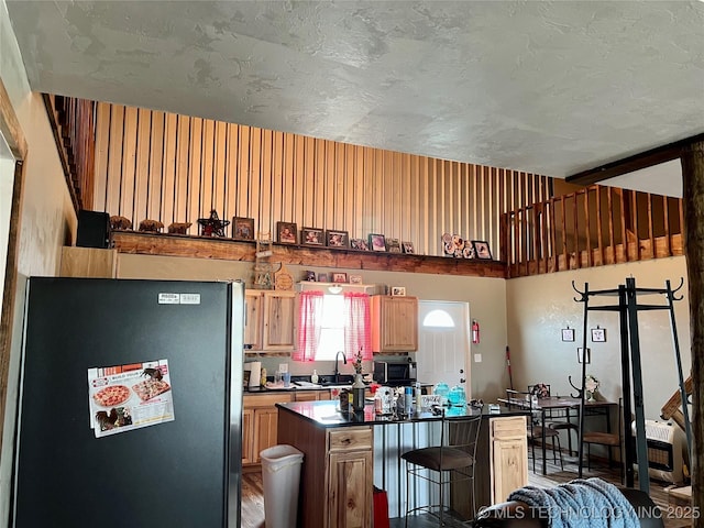 3226 Lark Rd, Kingston, OK 73439 - kitchen featuring appliances with stainless steel finishes, a breakfast bar area, a sink, a kitchen island, and dark countertops