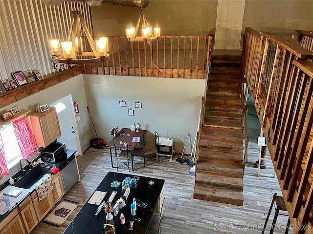 3226 Lark Rd, Kingston, OK 73439 - living area featuring a chandelier, wood finished floors, stairway, and a towering ceiling