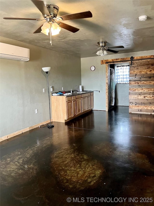 3226 Lark Rd, Kingston, OK 73439 - kitchen featuring a wall mounted AC, ceiling fan, finished concrete flooring, and a sink