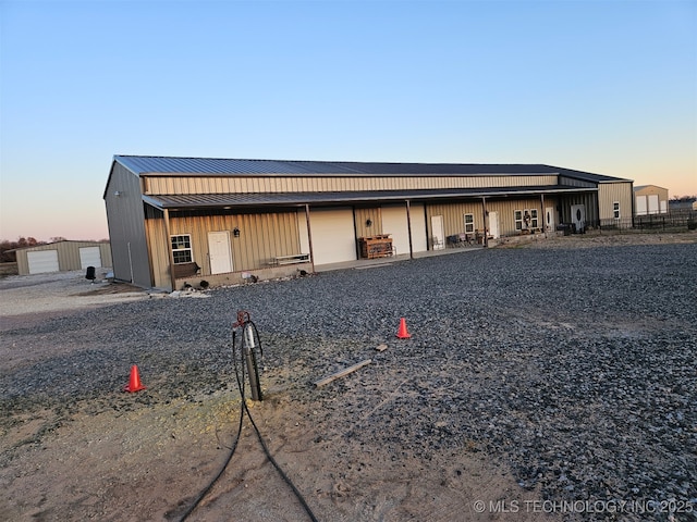 3226 Lark Rd, Kingston, OK 73439 - view of front of home with a garage, metal roof, a standing seam roof, and board and batten siding