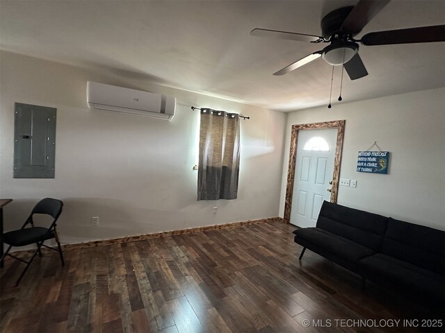 3226 Lark Rd, Kingston, OK 73439 - living area with a wall mounted AC, electric panel, a ceiling fan, wood finished floors, and baseboards
