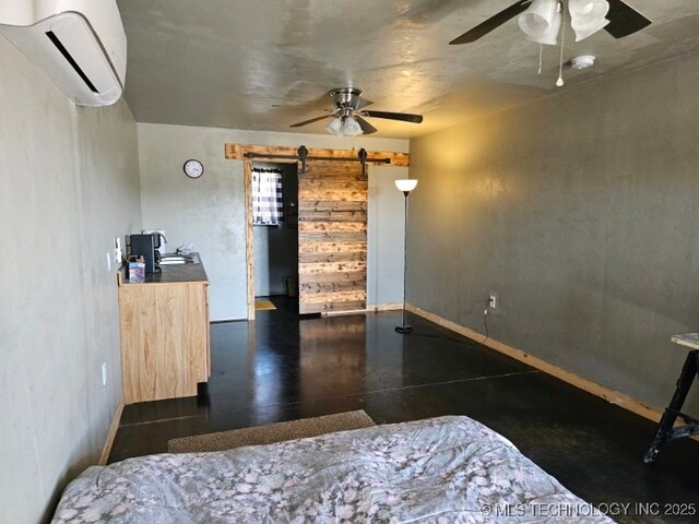 3226 Lark Rd, Kingston, OK 73439 - bedroom with a wall mounted air conditioner, a barn door, baseboards, and ceiling fan