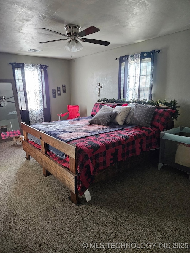 3226 Lark Rd, Kingston, OK 73439 - carpeted bedroom with multiple windows and a ceiling fan
