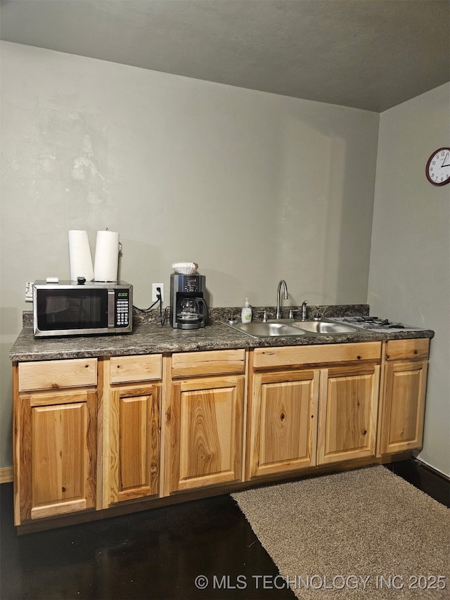 3226 Lark Rd, Kingston, OK 73439 - kitchen featuring stainless steel microwave, a sink, and dark countertops