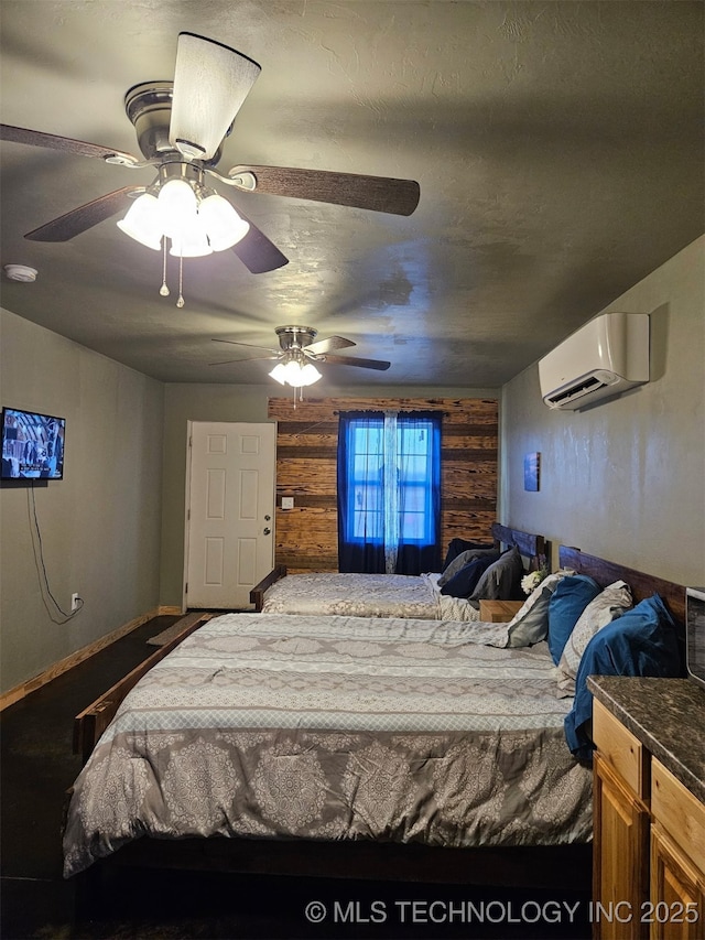 3226 Lark Rd, Kingston, OK 73439 - bedroom with an AC wall unit, wood walls, a ceiling fan, and baseboards