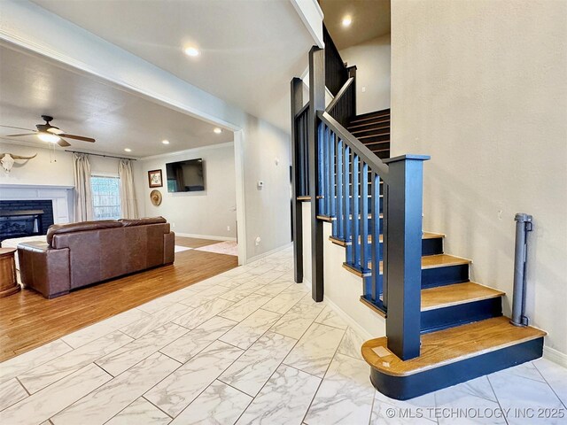 103 S Harrison Ave, Tahlequah, OK 74464 - stairway with a ceiling fan, marble finish floors, a glass covered fireplace, baseboards, and recessed lighting