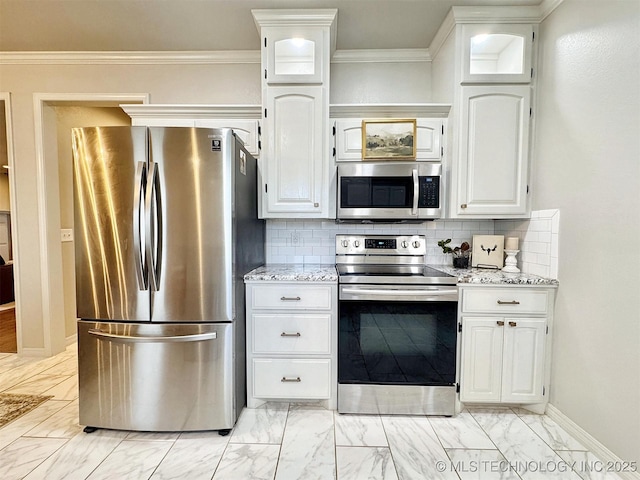 103 S Harrison Ave, Tahlequah, OK 74464 - kitchen featuring stainless steel appliances, light marble finish flooring, white cabinetry, baseboards, and ornamental molding