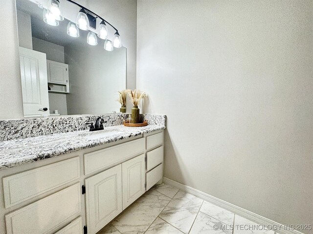 103 S Harrison Ave, Tahlequah, OK 74464 - bathroom with marble finish floors, vanity, and baseboards