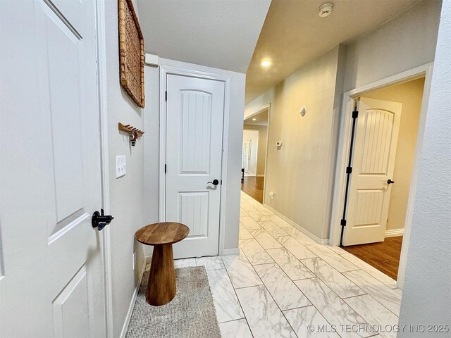 103 S Harrison Ave, Tahlequah, OK 74464 - hallway with light marble finish flooring, baseboards, and recessed lighting