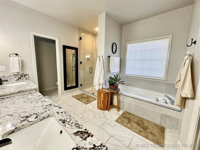 103 S Harrison Ave, Tahlequah, OK 74464 - bathroom featuring a garden tub, double vanity, a stall shower, toilet, and marble look tiles
