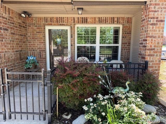 1620 Shenandoah Dr, Ardmore, OK 73401 - doorway to property featuring brick siding and covered porch