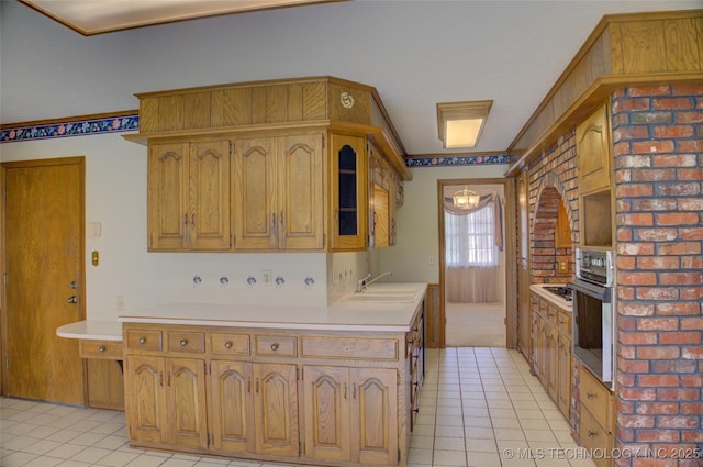 6788 E 66th Pl, Tulsa, OK 74133 - kitchen featuring stainless steel oven, a sink, light countertops, light tile patterned floors, and brown cabinetry