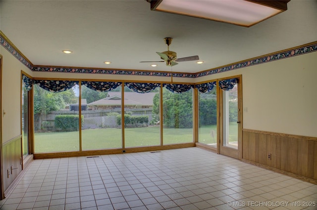 6788 E 66th Pl, Tulsa, OK 74133 - unfurnished sunroom with wainscoting, tile patterned flooring, wood walls, and recessed lighting