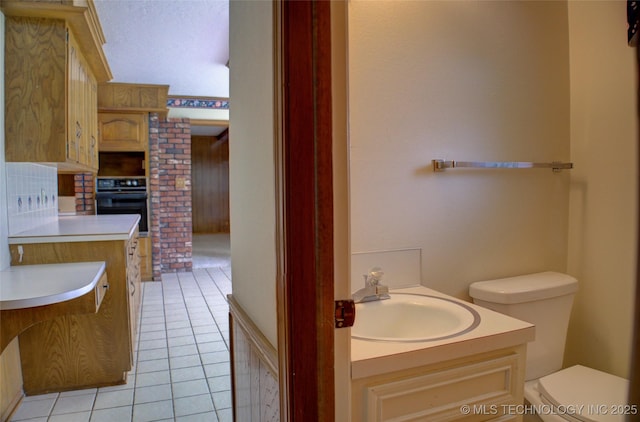 6788 E 66th Pl, Tulsa, OK 74133 - half bathroom with toilet, tile patterned flooring, and vanity