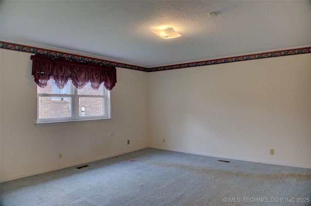 6788 E 66th Pl, Tulsa, OK 74133 - unfurnished room featuring carpet flooring, baseboards, and a textured ceiling