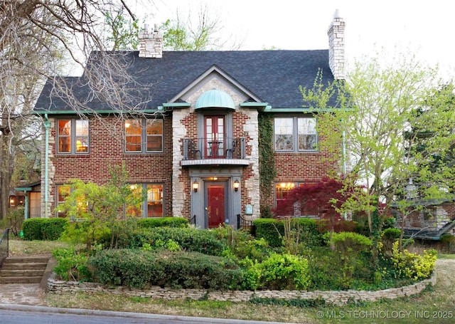 640 W 14th St, Tulsa, OK 74127 - view of front of house with a chimney, a balcony, and brick siding
